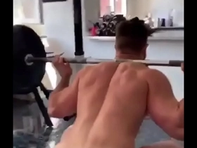 Bodybuilder squatting naked
